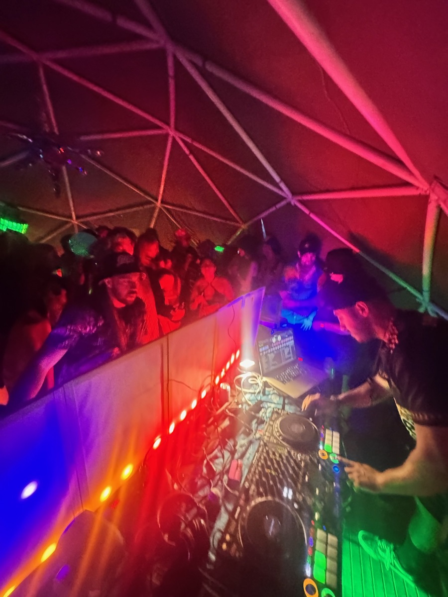 The Dome — 24-foot geodesic dome lit up at night